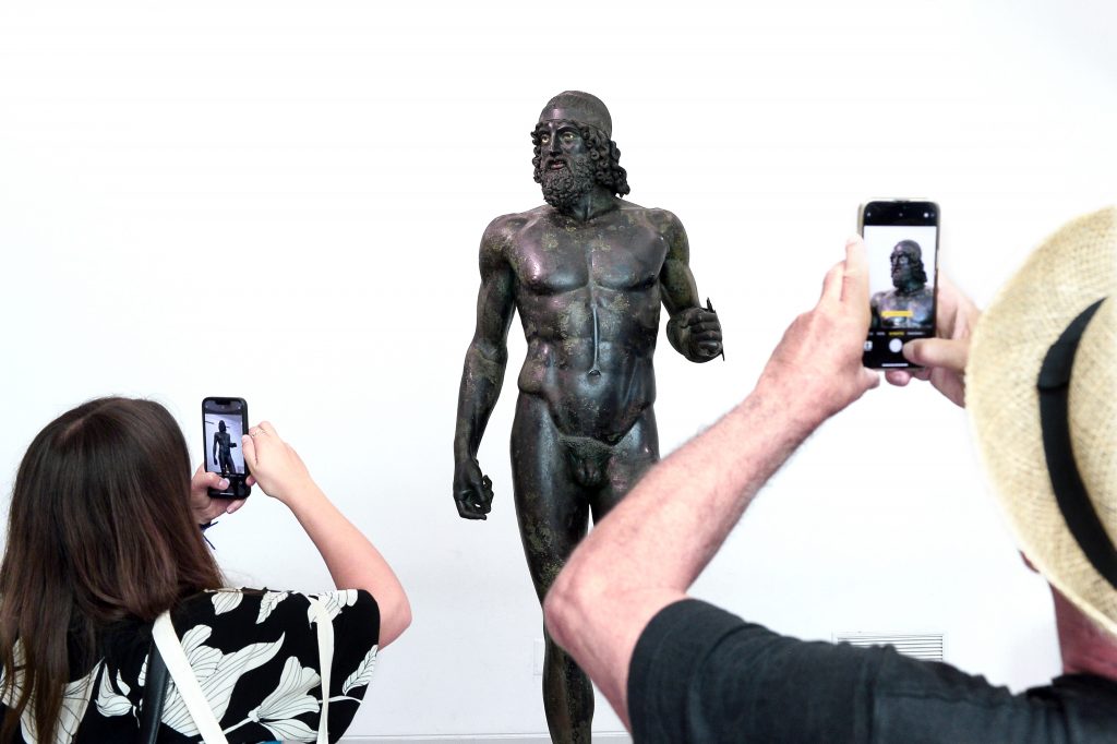 REGGIO CALABRIA, ITALY - AUGUST 05: Visitors admires the Riace Bronzes statues masterpieces from Magna Graecia culture part of the permanent collections of the MArRC National Archaeological Museum of Reggio Calabria site of the "San Casciano And Riace Bronze" exhibition at MArRC - National Archaeological Museum on August 05, 2024 in Reggio Calabria, Italy. (Photo by Roberto Serra - Iguana Press/Getty Images)